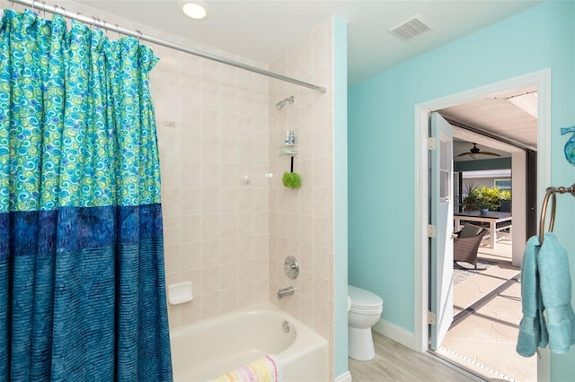 bathroom with wood-type flooring, toilet, and shower / bath combo with shower curtain