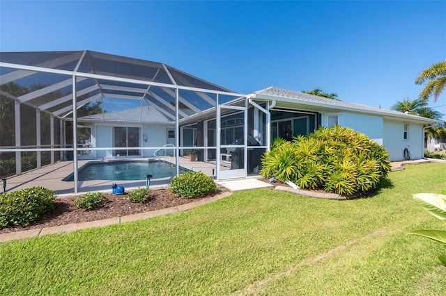 rear view of property featuring a lawn and glass enclosure