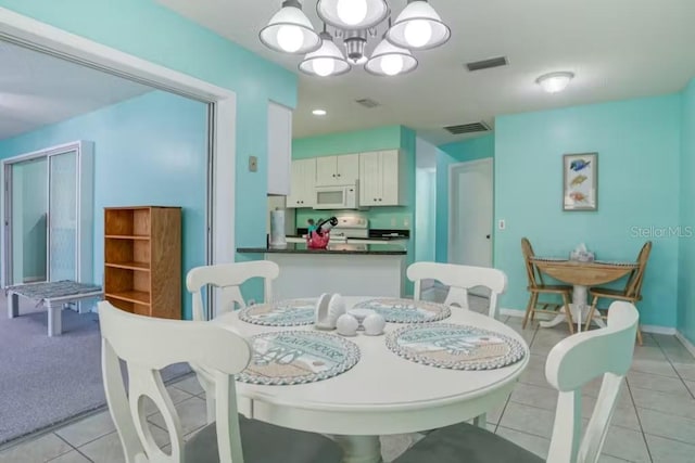 dining room featuring light tile patterned floors and a chandelier