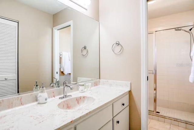 bathroom with vanity, tile patterned floors, and an enclosed shower