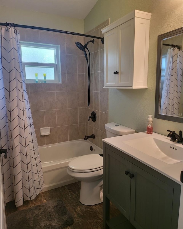 full bathroom with shower / bathtub combination with curtain, wood-type flooring, oversized vanity, and toilet