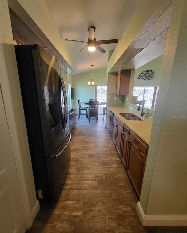 kitchen featuring black appliances, sink, plenty of natural light, and pendant lighting