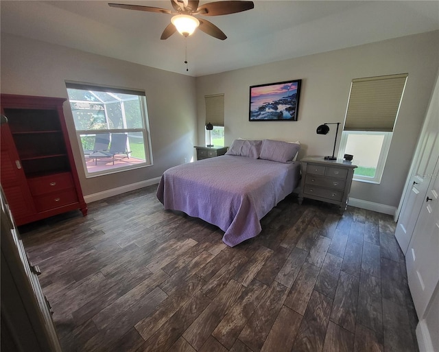 bedroom with ceiling fan, dark wood-style flooring, and baseboards