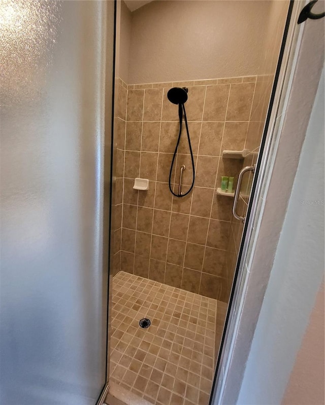 bathroom with a shower with door