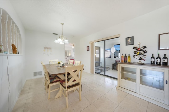 dining room featuring a chandelier and light tile patterned floors