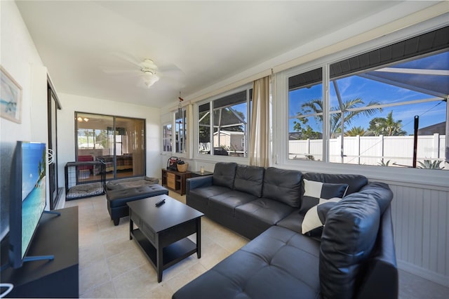 living room with ceiling fan and light tile patterned flooring