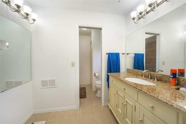 bathroom featuring vanity, toilet, and tile patterned flooring