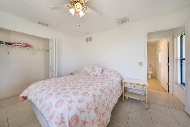 bedroom with ceiling fan, a closet, and light tile patterned floors