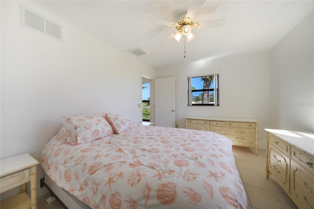 tiled bedroom featuring ceiling fan