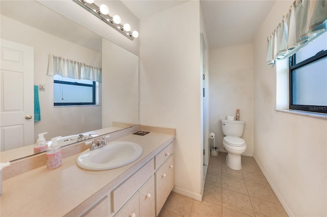 bathroom with tile patterned flooring, vanity, and toilet