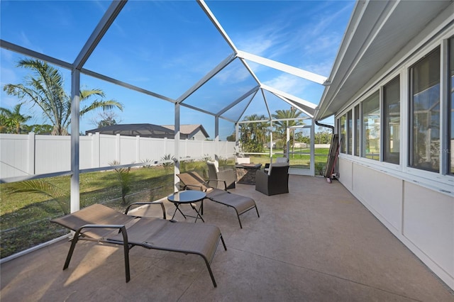 view of patio featuring glass enclosure