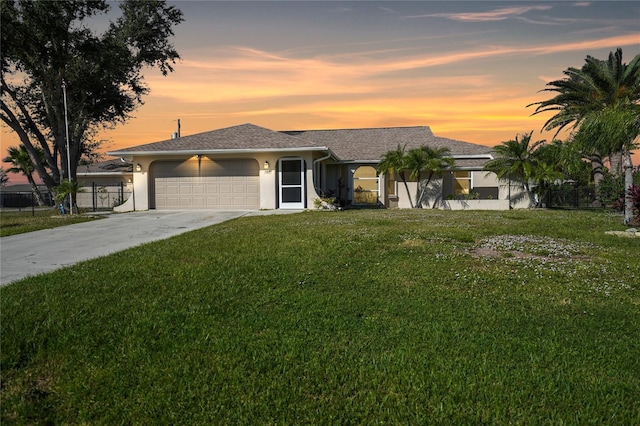 view of front of house featuring a garage and a lawn