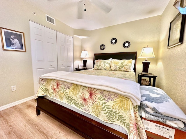 bedroom with ceiling fan, hardwood / wood-style floors, and a closet