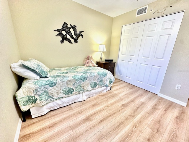 bedroom featuring a closet and light wood-type flooring