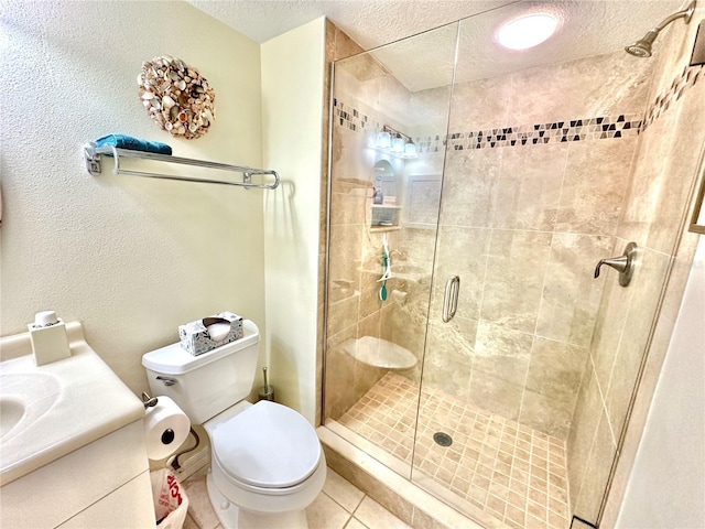 bathroom with an enclosed shower, vanity, a textured ceiling, tile patterned floors, and toilet