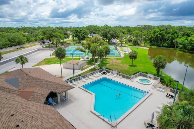 view of swimming pool featuring a patio and a water view