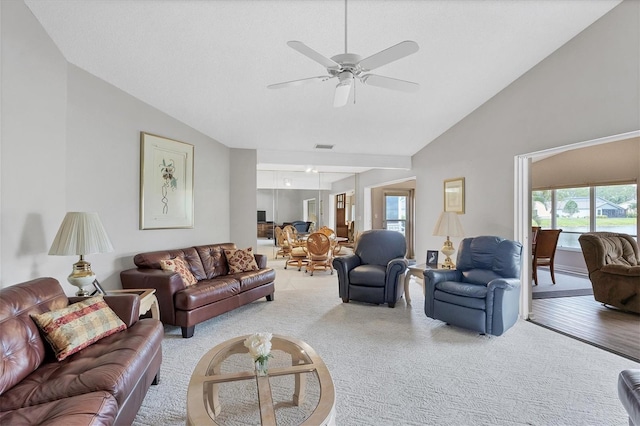 living room featuring ceiling fan, carpet floors, and lofted ceiling