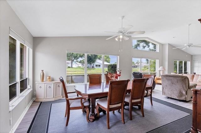 dining area with hardwood / wood-style flooring, vaulted ceiling, plenty of natural light, and ceiling fan