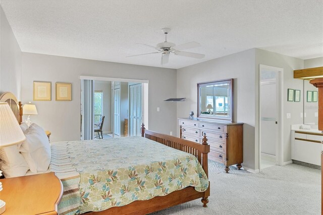 carpeted bedroom with a textured ceiling, access to outside, and ceiling fan