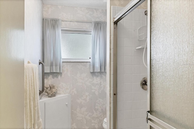 bathroom featuring toilet and walk in shower