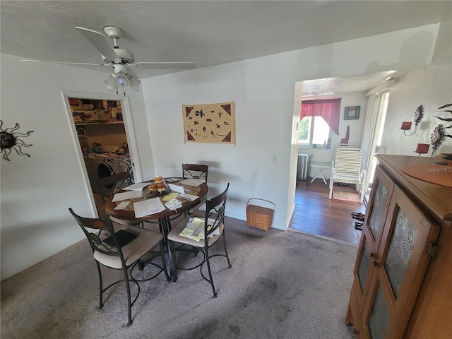 dining space featuring carpet and ceiling fan