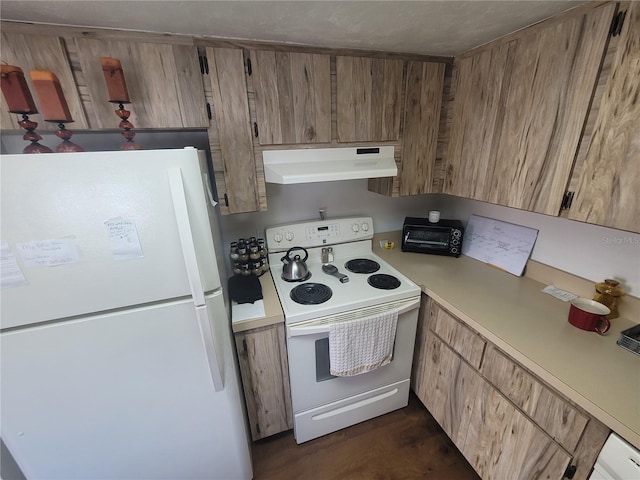22481 Westchester Blvd Unit B40, Punta Gorda, FL 33980 - kitchen featuring white appliances, under cabinet range hood, light countertops, built in desk, and dark wood-type flooring
