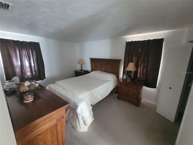 carpeted bedroom with a closet