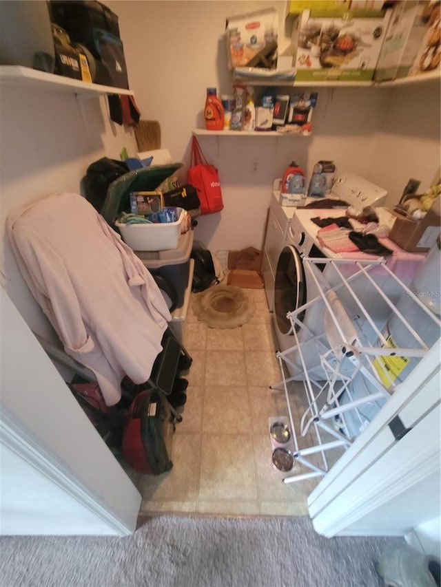 laundry area with tile flooring and washer and clothes dryer