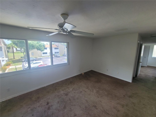 carpeted empty room with plenty of natural light and ceiling fan