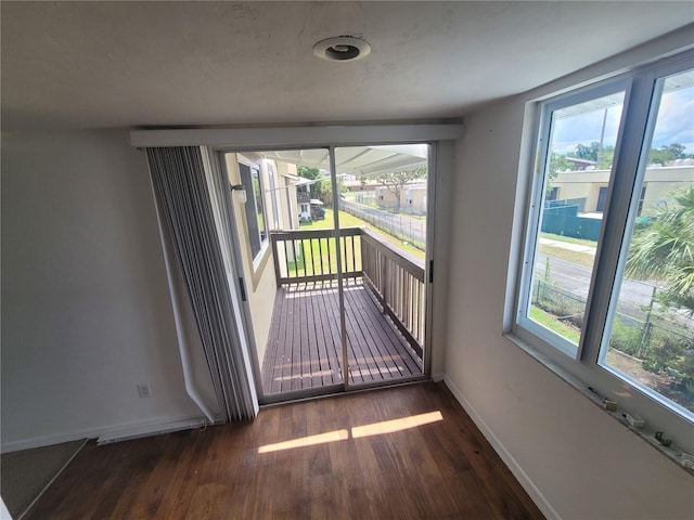 22481 Westchester Blvd Unit B35, Punta Gorda, FL 33980 - empty room featuring wood finished floors, baseboards, and healthy amount of natural light