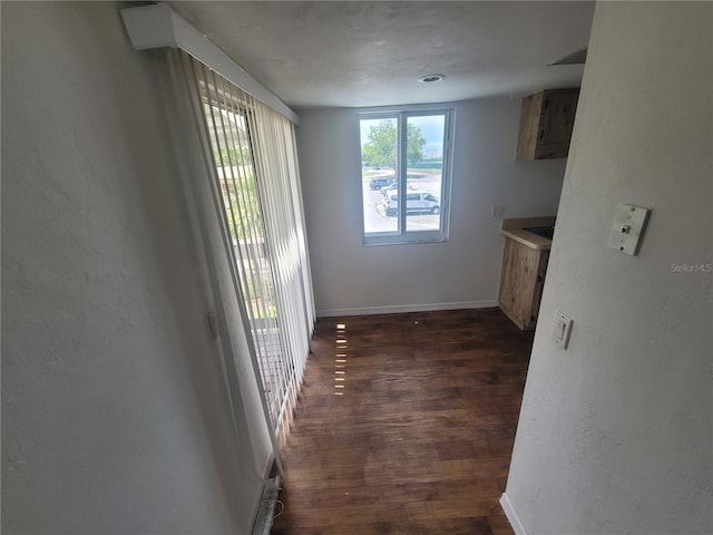 22481 Westchester Blvd Unit B35, Punta Gorda, FL 33980 - unfurnished dining area featuring dark wood-style flooring and baseboards