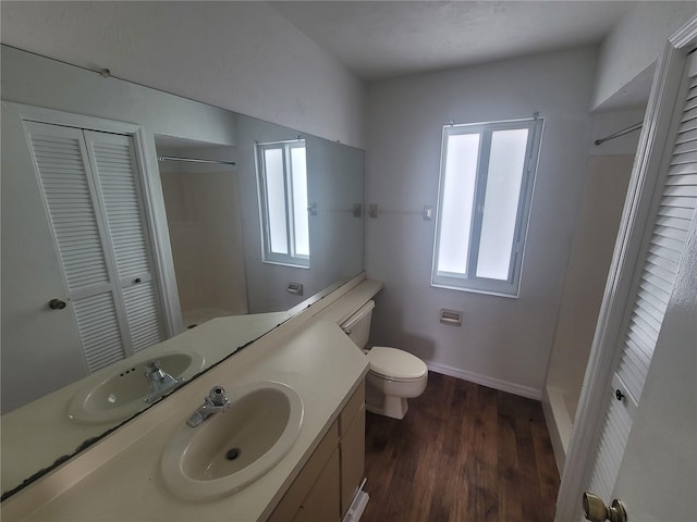 bathroom with oversized vanity, hardwood / wood-style flooring, and toilet