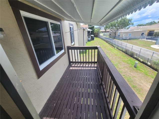 wooden terrace featuring a lawn