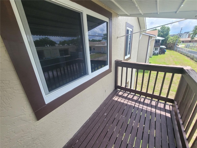 wooden deck featuring a lawn