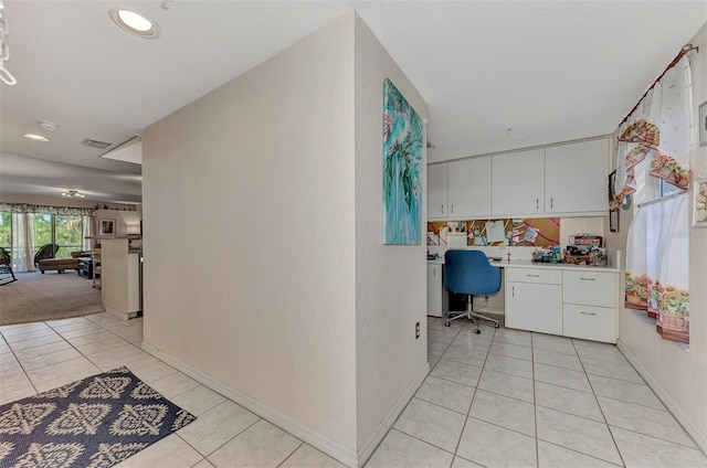 hallway with light tile patterned floors