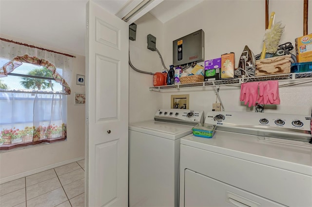 clothes washing area featuring washer and dryer and light tile patterned floors