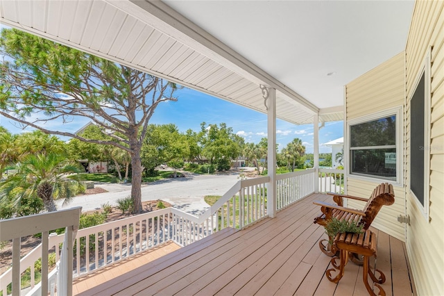 wooden terrace featuring covered porch