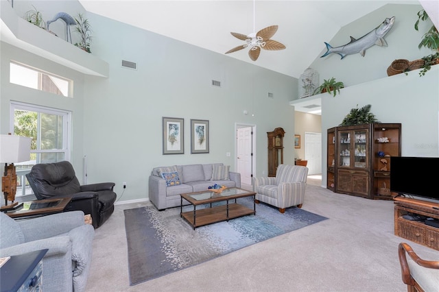 carpeted living room featuring high vaulted ceiling and ceiling fan