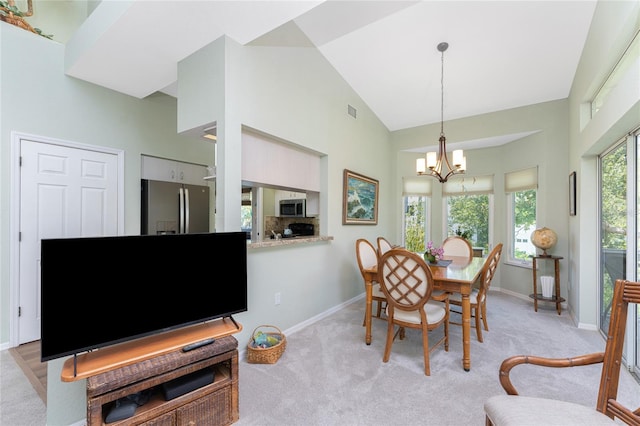 carpeted dining space with high vaulted ceiling and a notable chandelier