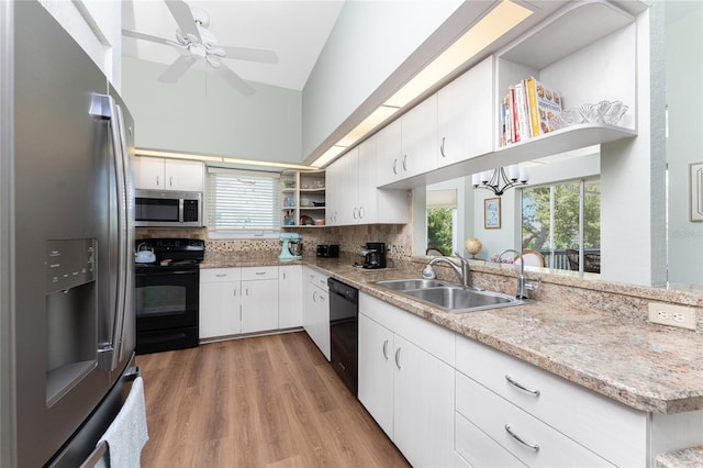 kitchen with black appliances, kitchen peninsula, sink, tasteful backsplash, and white cabinetry