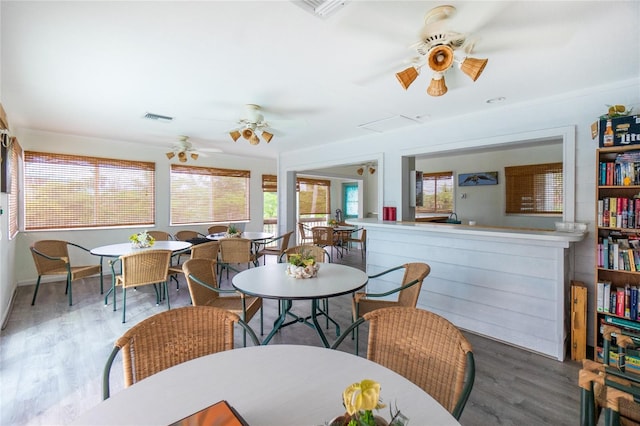 dining space with hardwood / wood-style flooring and ceiling fan