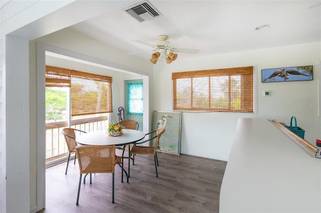 dining space with ceiling fan and dark hardwood / wood-style floors