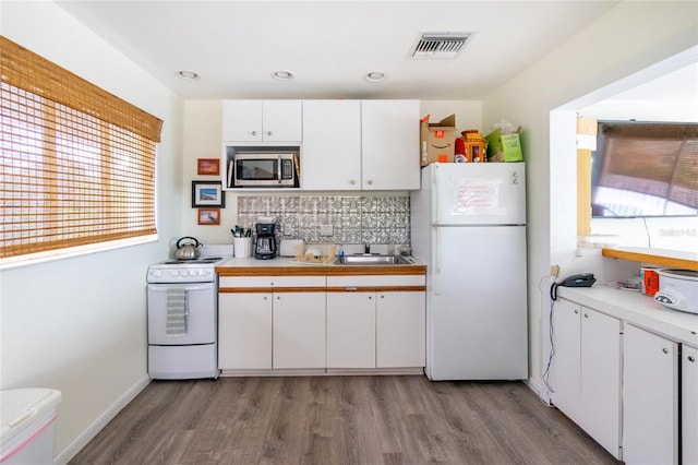 kitchen featuring white cabinetry, white appliances, light hardwood / wood-style flooring, and tasteful backsplash