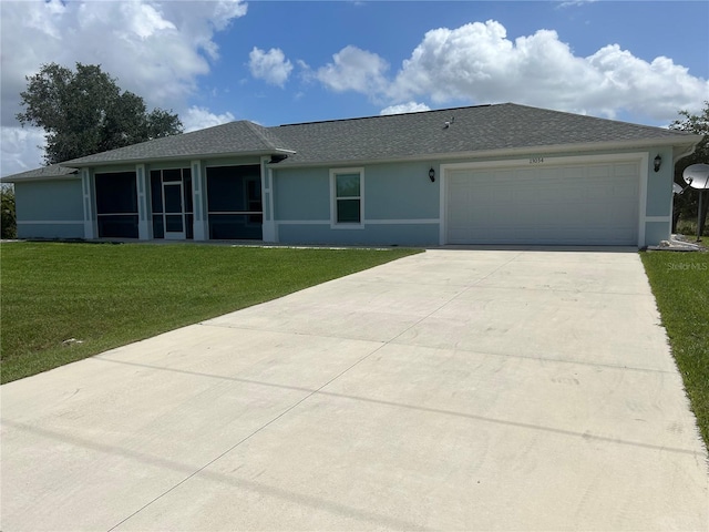 single story home with a sunroom, a garage, and a front lawn