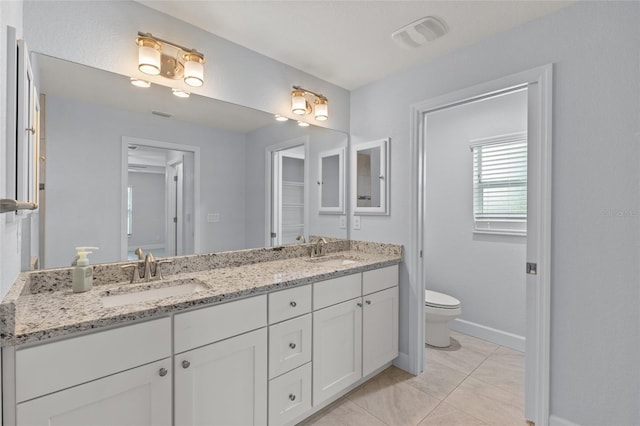 bathroom featuring tile patterned floors, vanity, and toilet