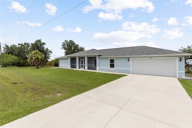 single story home with a sunroom, a garage, and a front yard