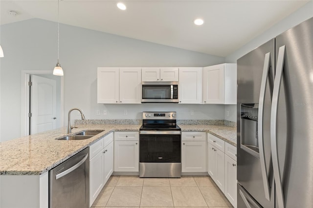 kitchen featuring stainless steel appliances, sink, pendant lighting, white cabinetry, and lofted ceiling