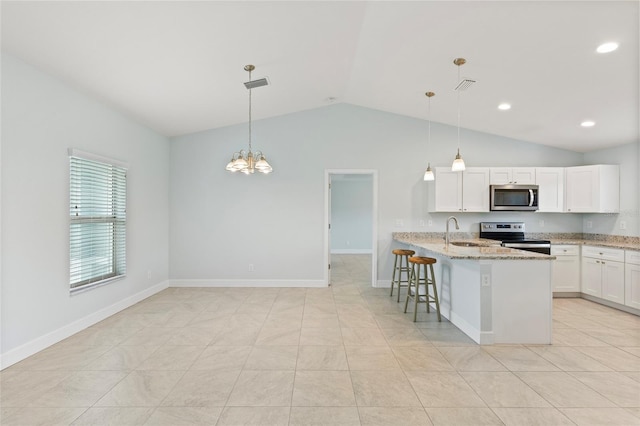 kitchen featuring white cabinets, sink, stainless steel appliances, and hanging light fixtures