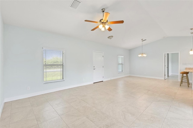 spare room featuring light tile patterned floors, ceiling fan with notable chandelier, and vaulted ceiling