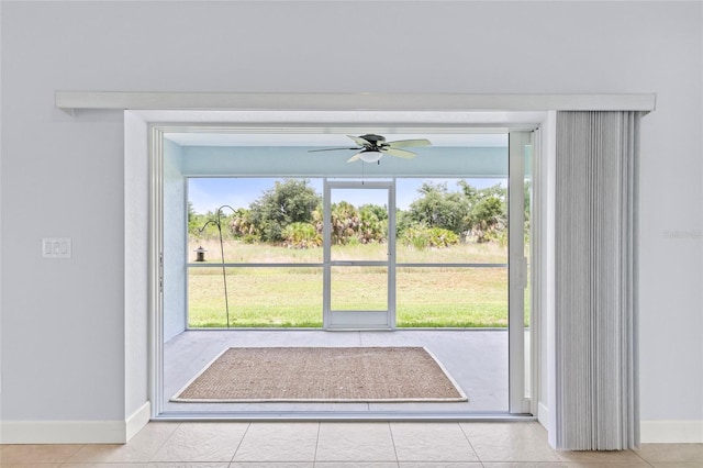 doorway to outside with ceiling fan, a healthy amount of sunlight, and light tile patterned flooring